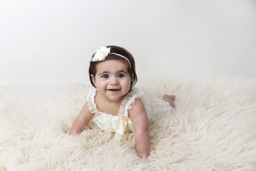 baby girl lifting on arms at Just Peachy Photography Baby Portrait Studio in Palatine IL | baby milestone portraits