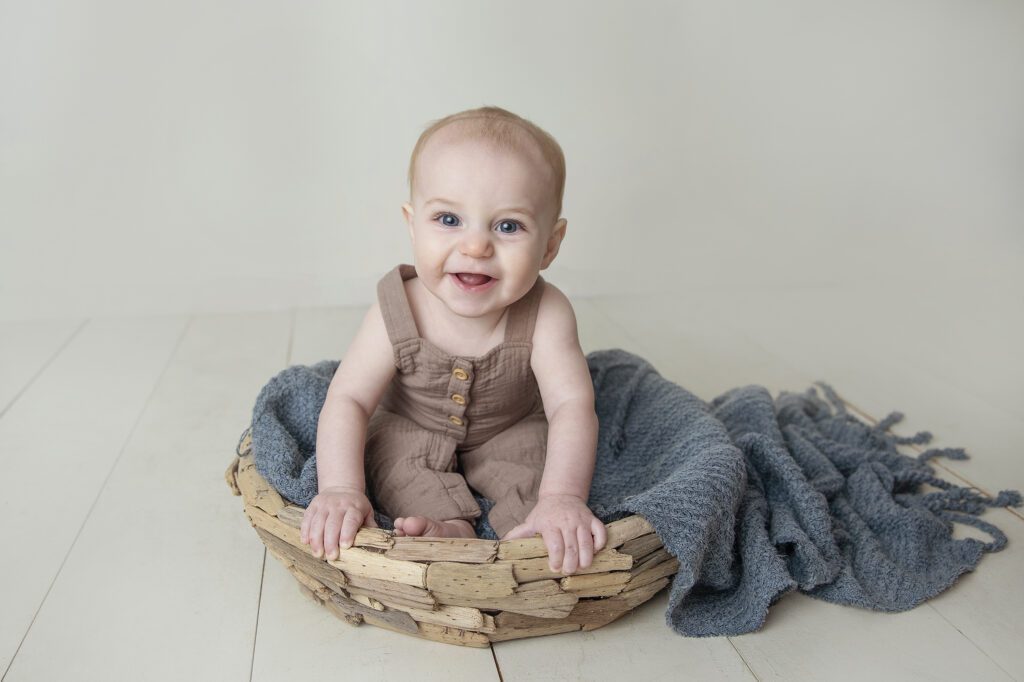 baby boy sitting in bowl at Just Peachy Photography Baby Portrait Studio in Palatine IL