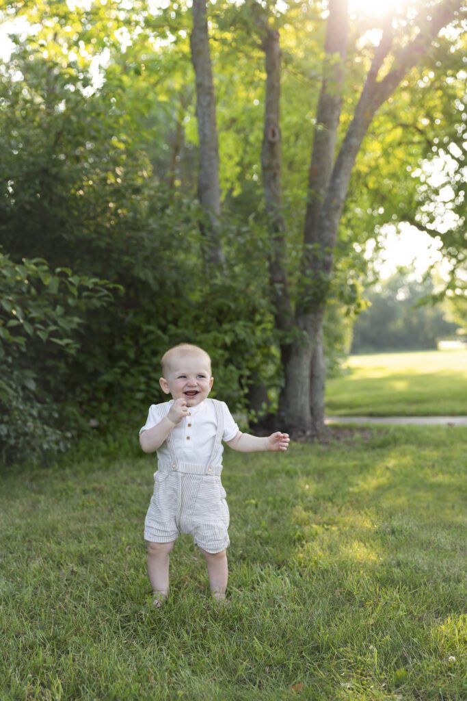 baby boy walking at Just Peachy Photography Baby Portrait Studio in Arlington Heights park | baby milestone portraits